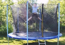 boy jumping on trampoline. the child plays on a trampoline outdoor